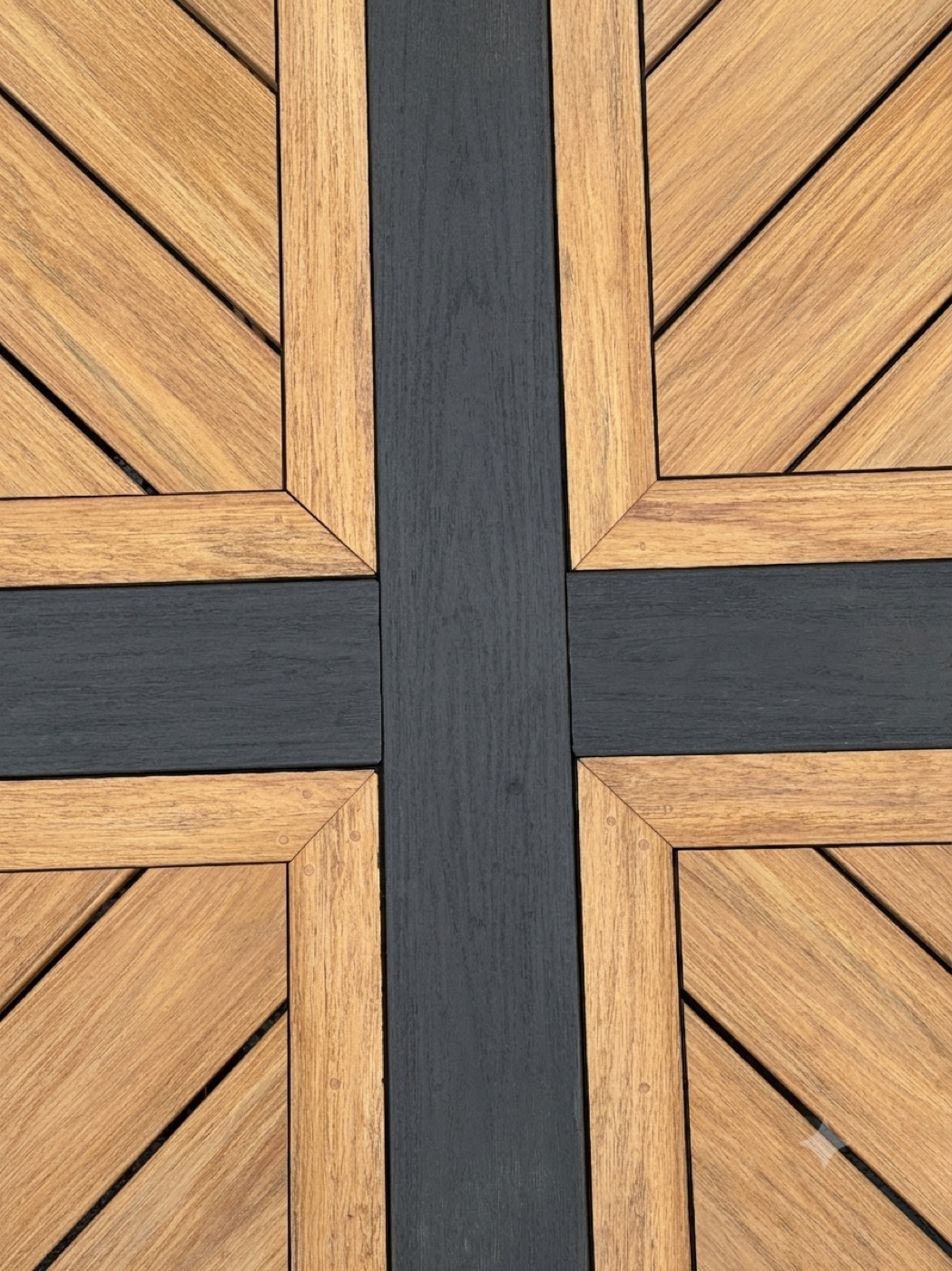 Close-up of a custom composite deck with a picture-frame parquet inlay and contrasting cross border
